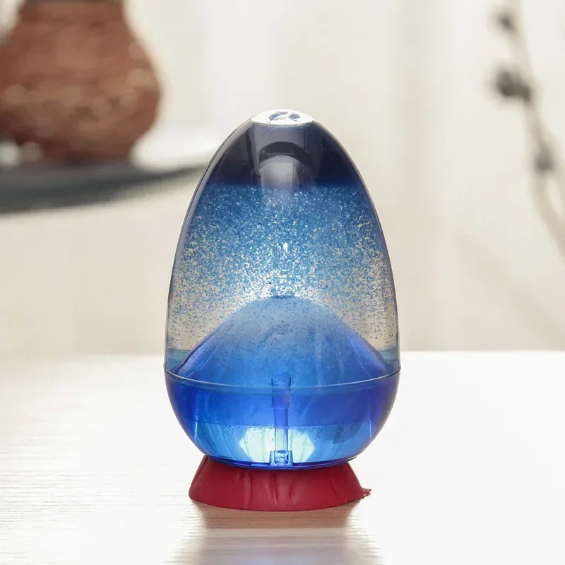 Gouttes d'huile colorée descendant lentement dans un timer liquide sensoriel